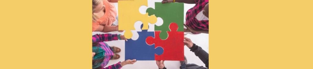 women fitting a puzzle together